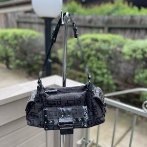 Guess logo studded black shoulder bag. In very good condition.